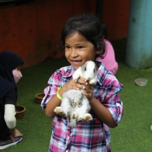 girl holding rabbit